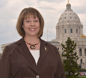 Tracy Hatch, MnDOT deputy commissioner, poses with Mn Capitol dome in background